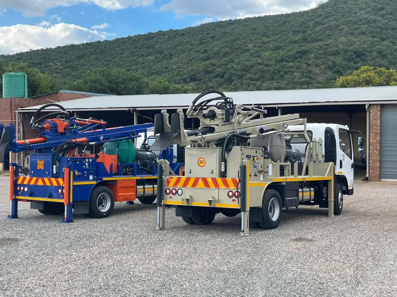 Truck-mounted SAR100 water well drill rig with compact mast operating in the field.