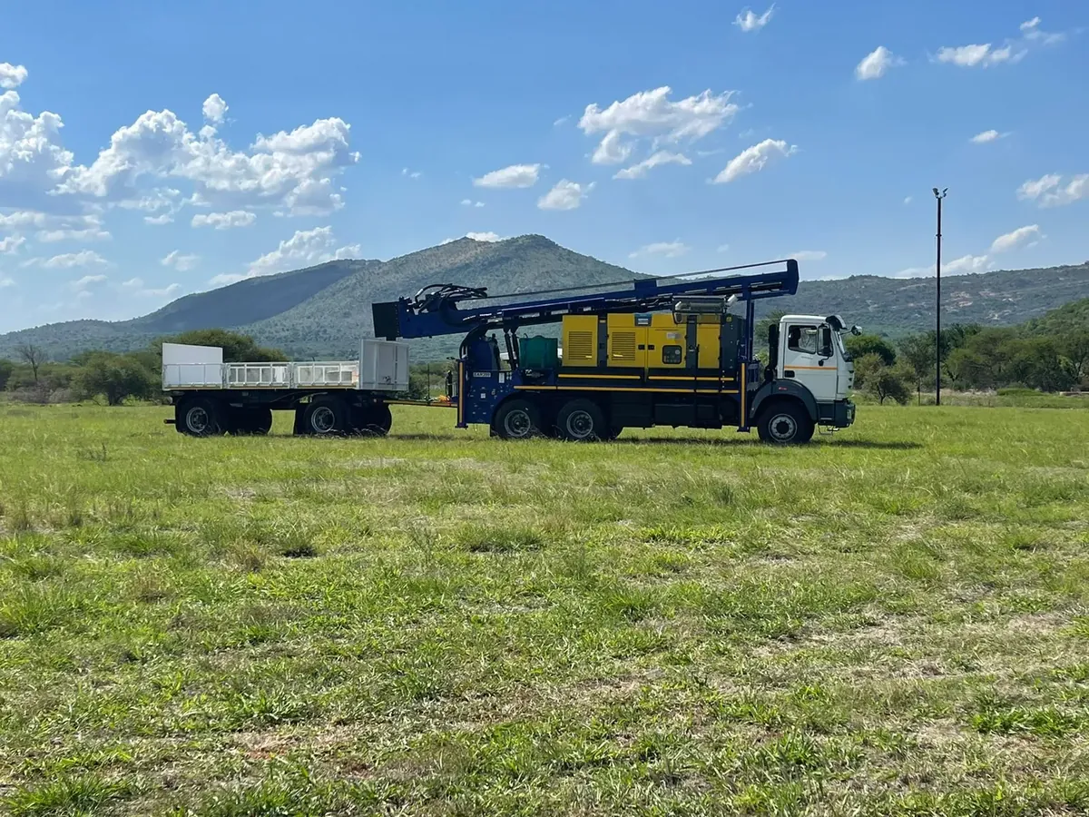 SAR200 truck-mounted drilling rig with support trailer on site