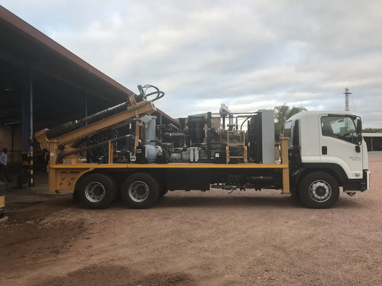 SAR210 utility and pole-hole drilling rig with short clearance mast mounted on a truck.