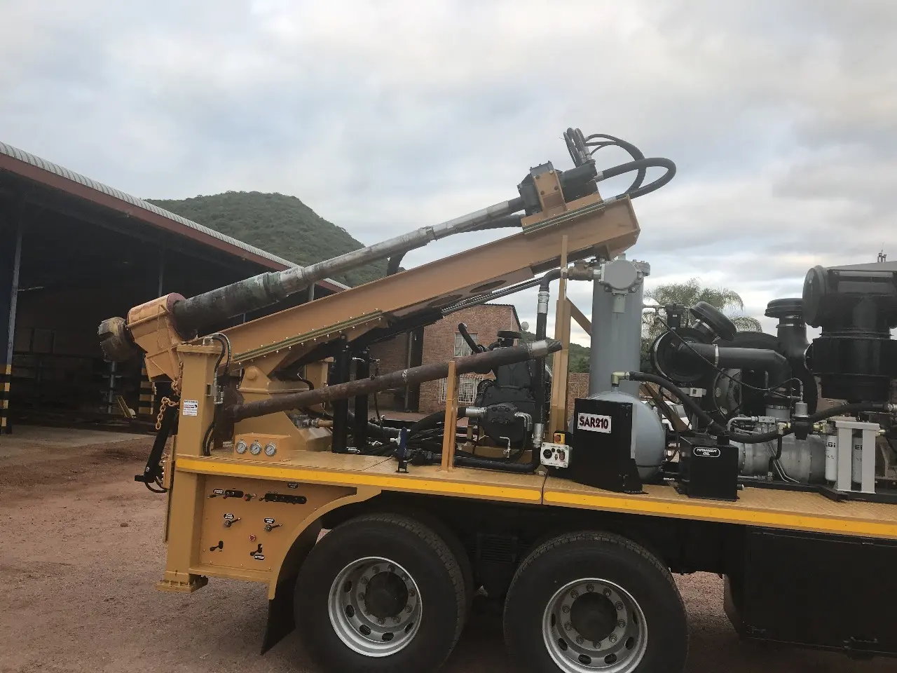 SAR210 utility and pole-hole drilling rig with short clearance mast mounted on a truck.