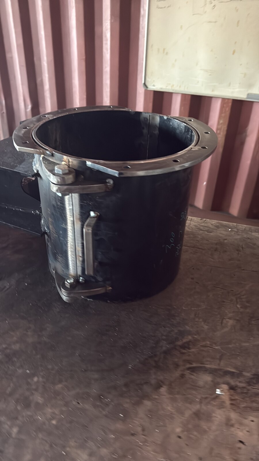 Finished black drill bush with flanged bolt-on top and a hinge on the split so it opens in two halves like a clamshell