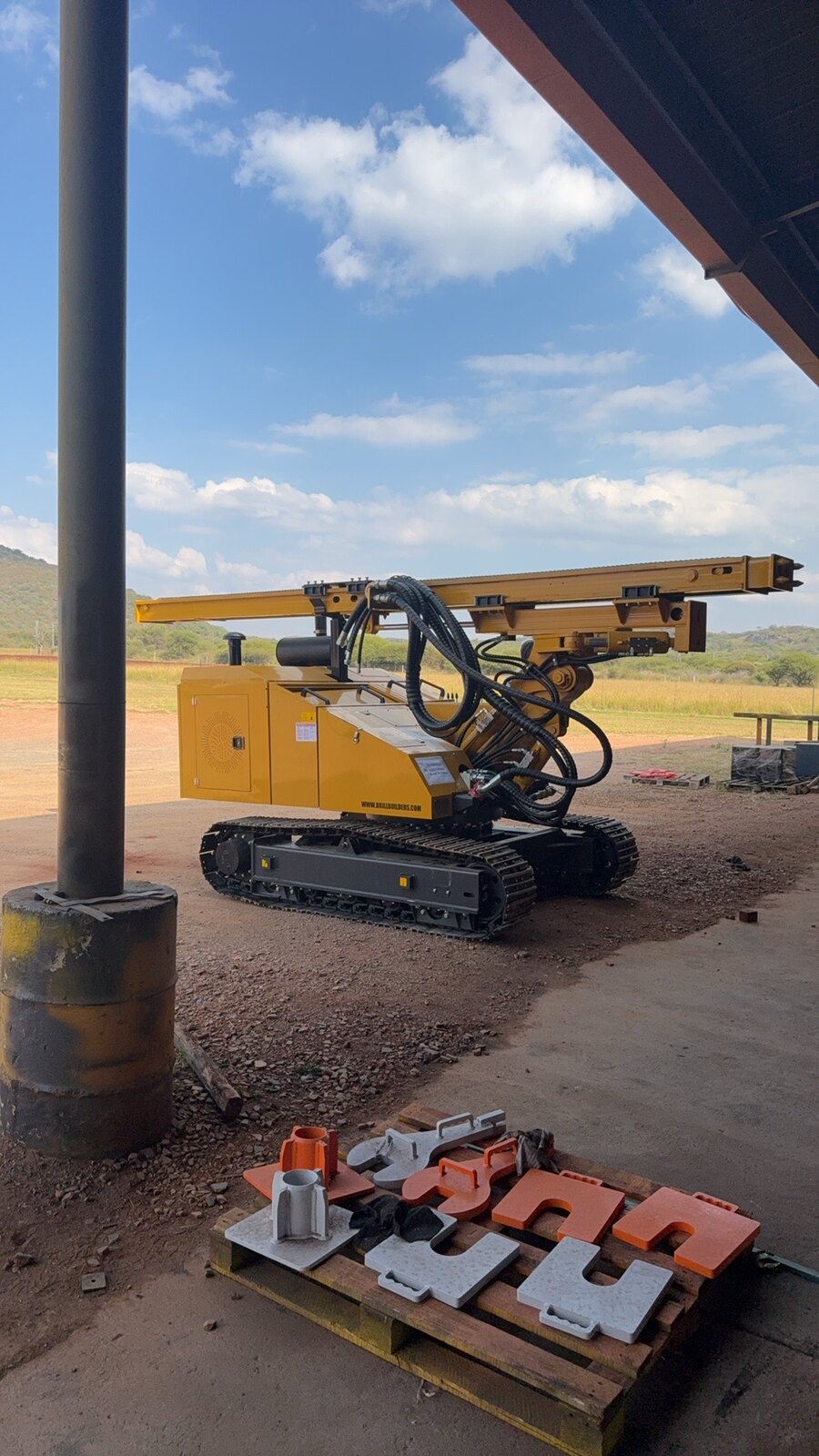 Finished JCS500 outdoors with drilling tooling and augers laid out on a pallet beside it